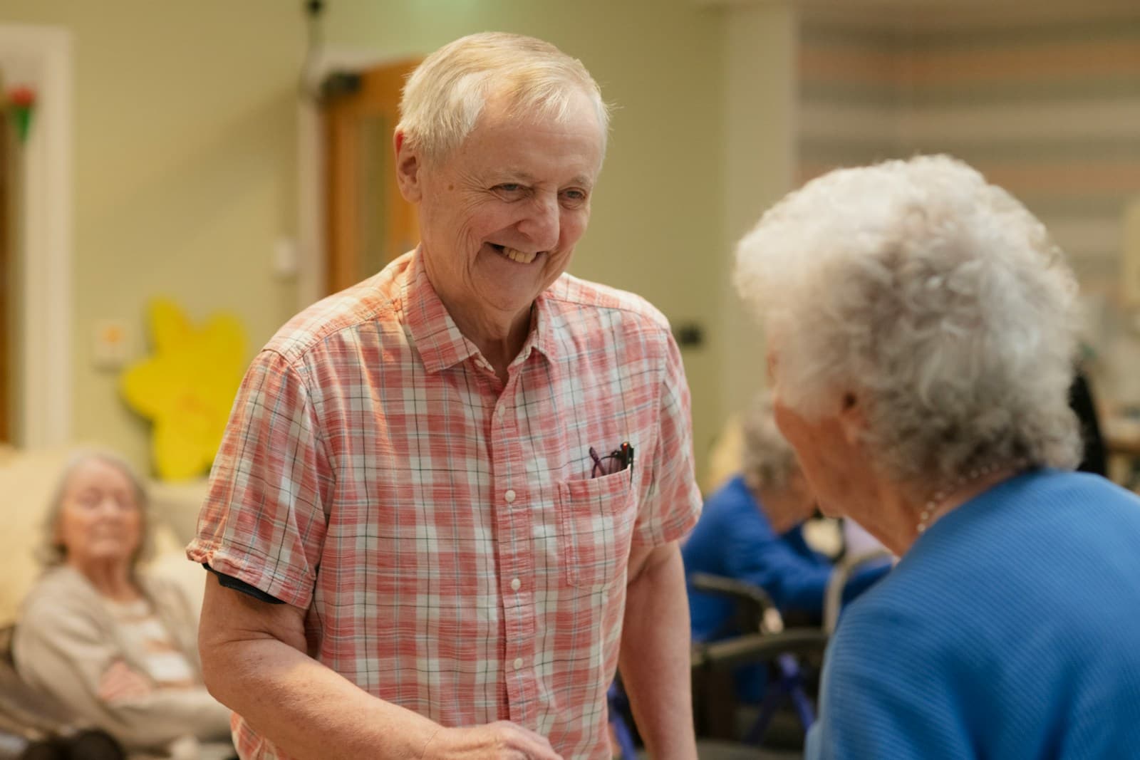 Older adults sharing a friendly conversation in a community room