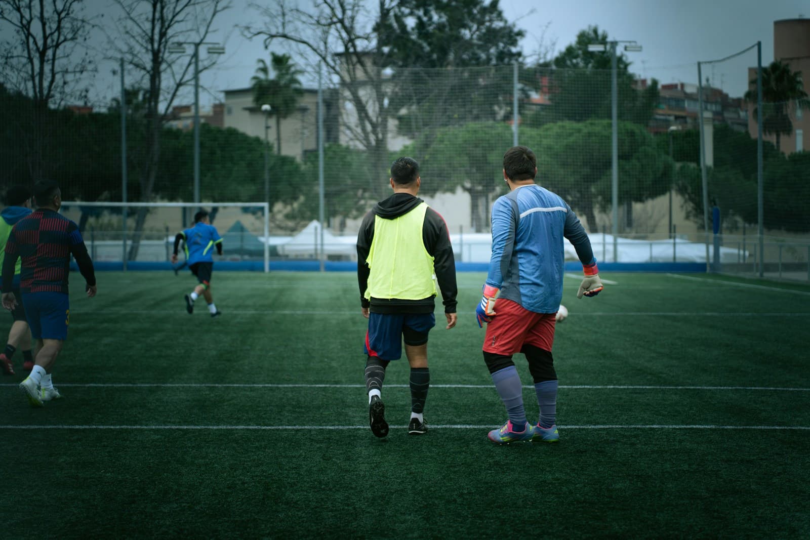 Soccer players practicing together on a neighborhood field